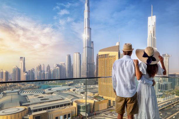 A couple enjoys a panoramic view of Dubai's skyline, symbolizing new opportunities for freelancers in the city.